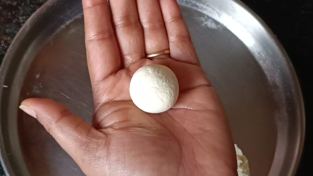 Shaping the paneer into perfect round shape small ball by using palm of the hand