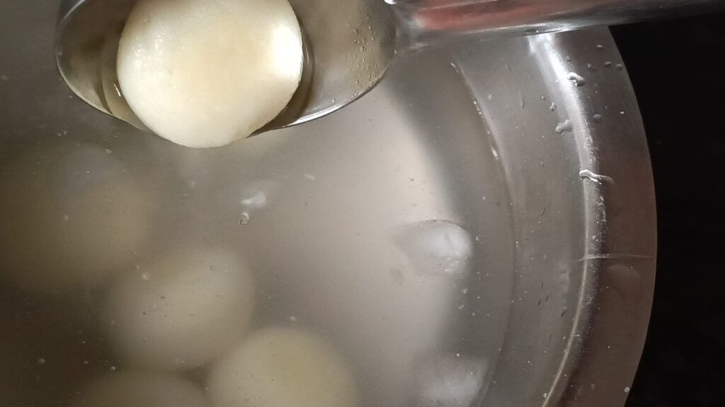 Transferring bengali rasgullas in cold syrup