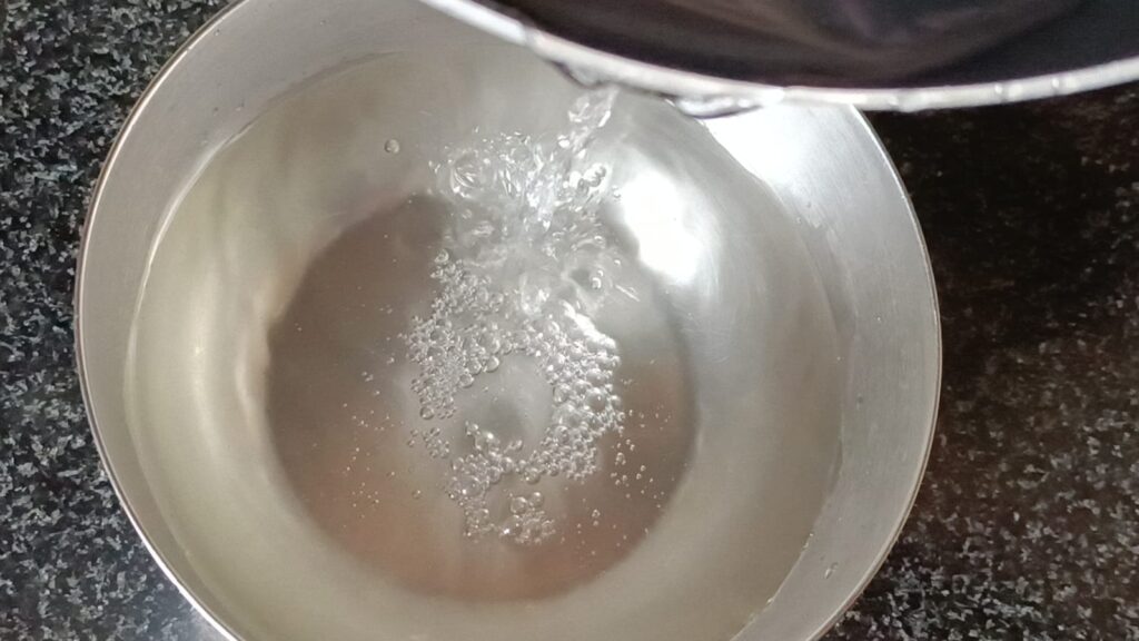 Transferring sugar syrup in another bowl for bengali rasgullas