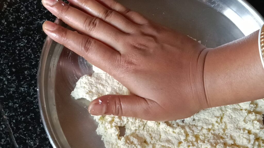 Rubbing paneer with the hand in a plate to make perfect bengali rasgullas