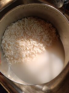 Draining water from rice to make veg fried rice