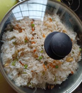 Basmati rice mixed with vegetables and cover with lid to make veg fried rice