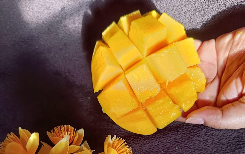 Cutting mango into pieces like cubes for mango chia seed pudding