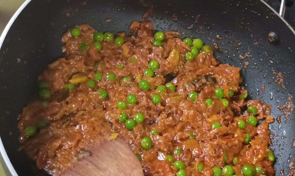 Cooking green peas with curd and masala for matar mushroom ki sabji