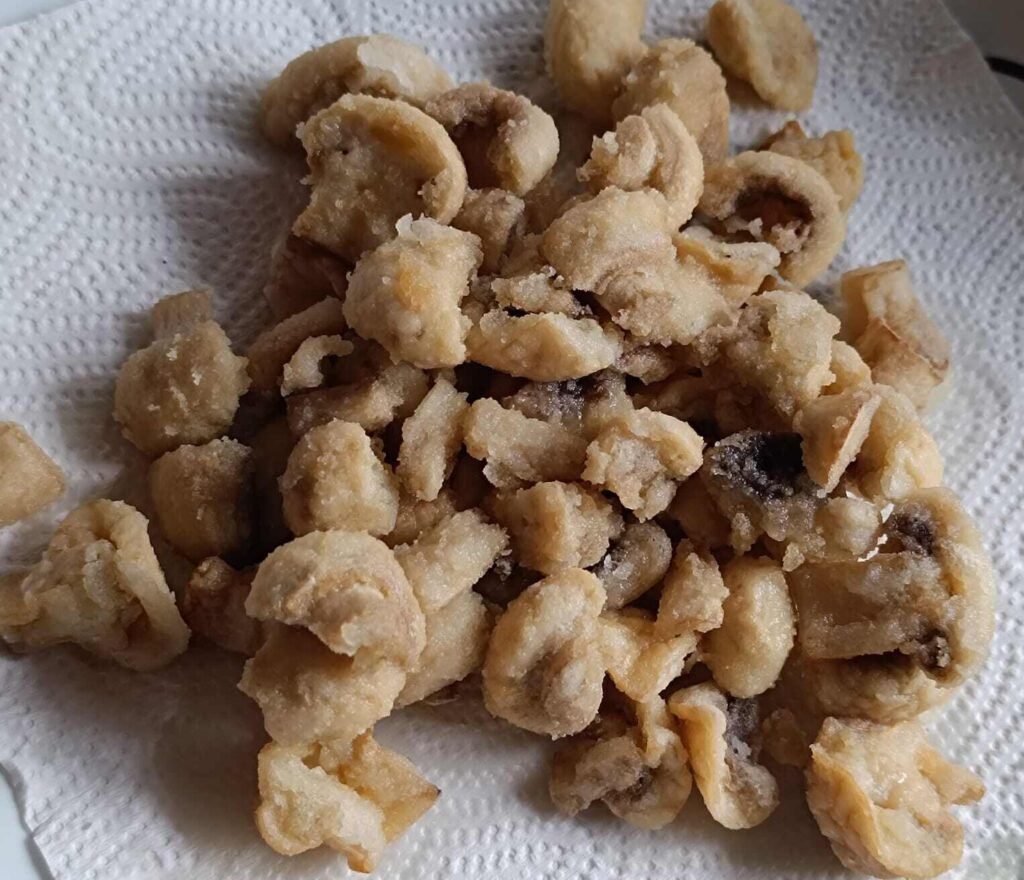 Fried mushroom placed on a tissue paper for chilli mushroom recipe