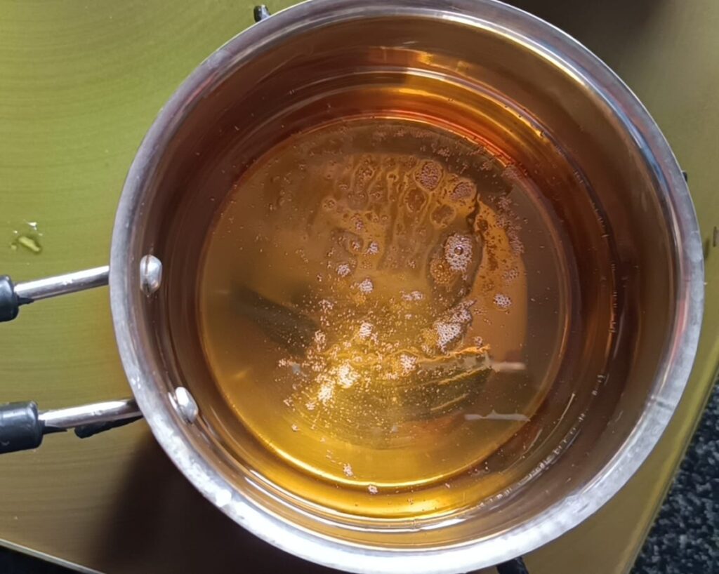 Heating oil in a pan for chilli mushroom recipe