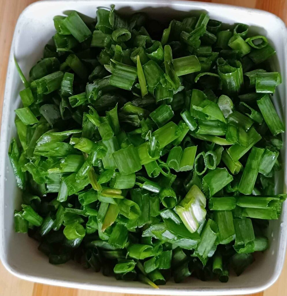 A bowl of chopped spring onions for chilli mushroom recipe