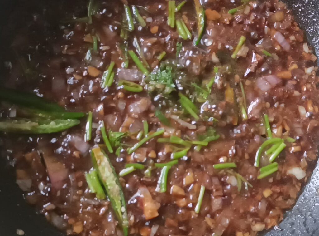 mixing dark soy sauce, green chilli paste, coriander stems, slit green chillies, salt, pepper, vinegar for veg chilli paneer